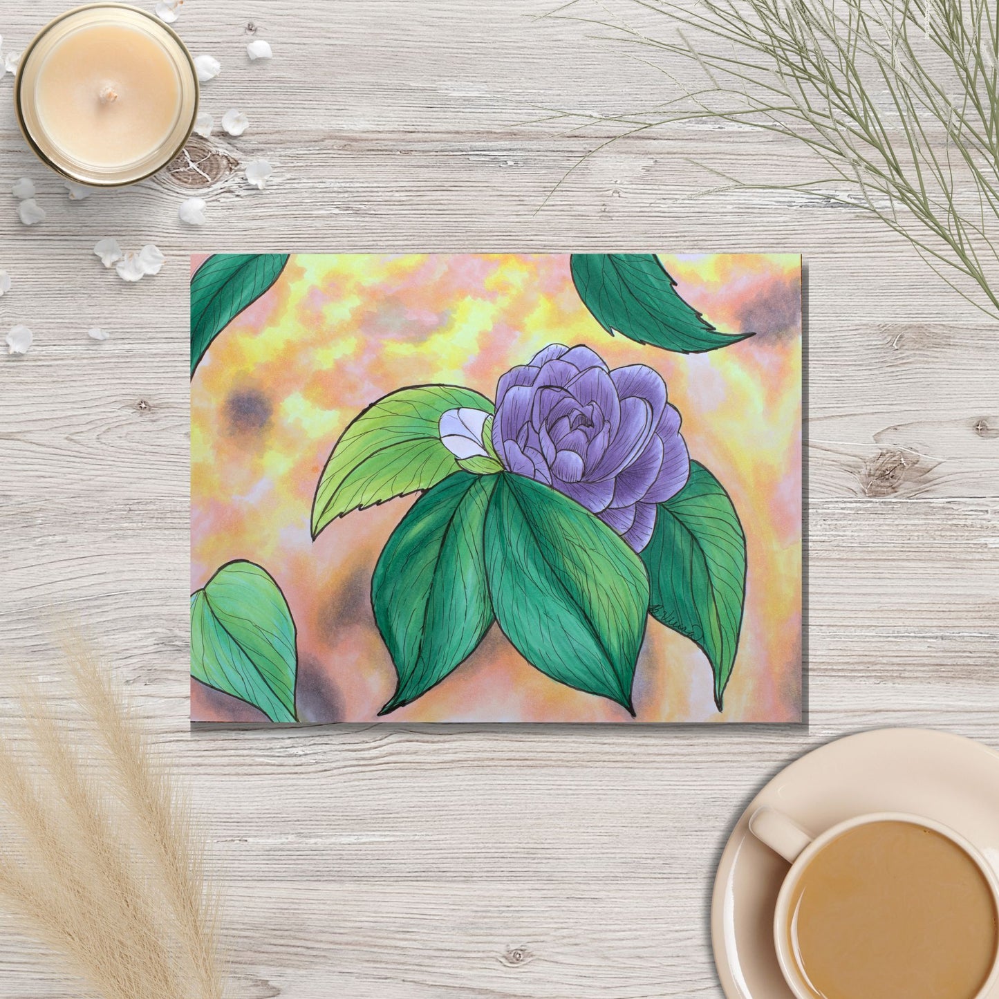 purple flower and green leaves design on a wooden surface with a candle and cup.