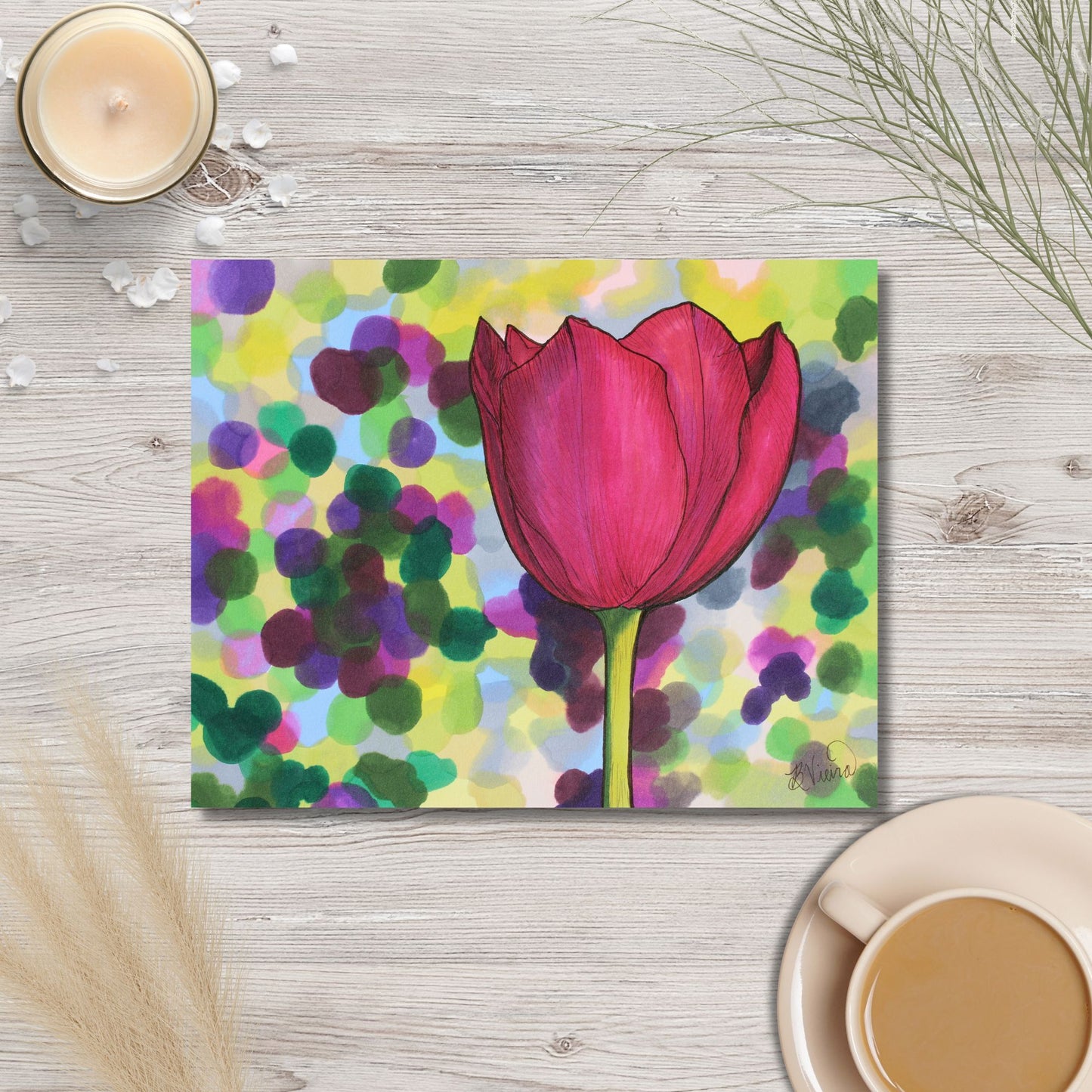 Colorful marker drawing of a pink tulip on a wooden surface with a cup of coffee and candle.