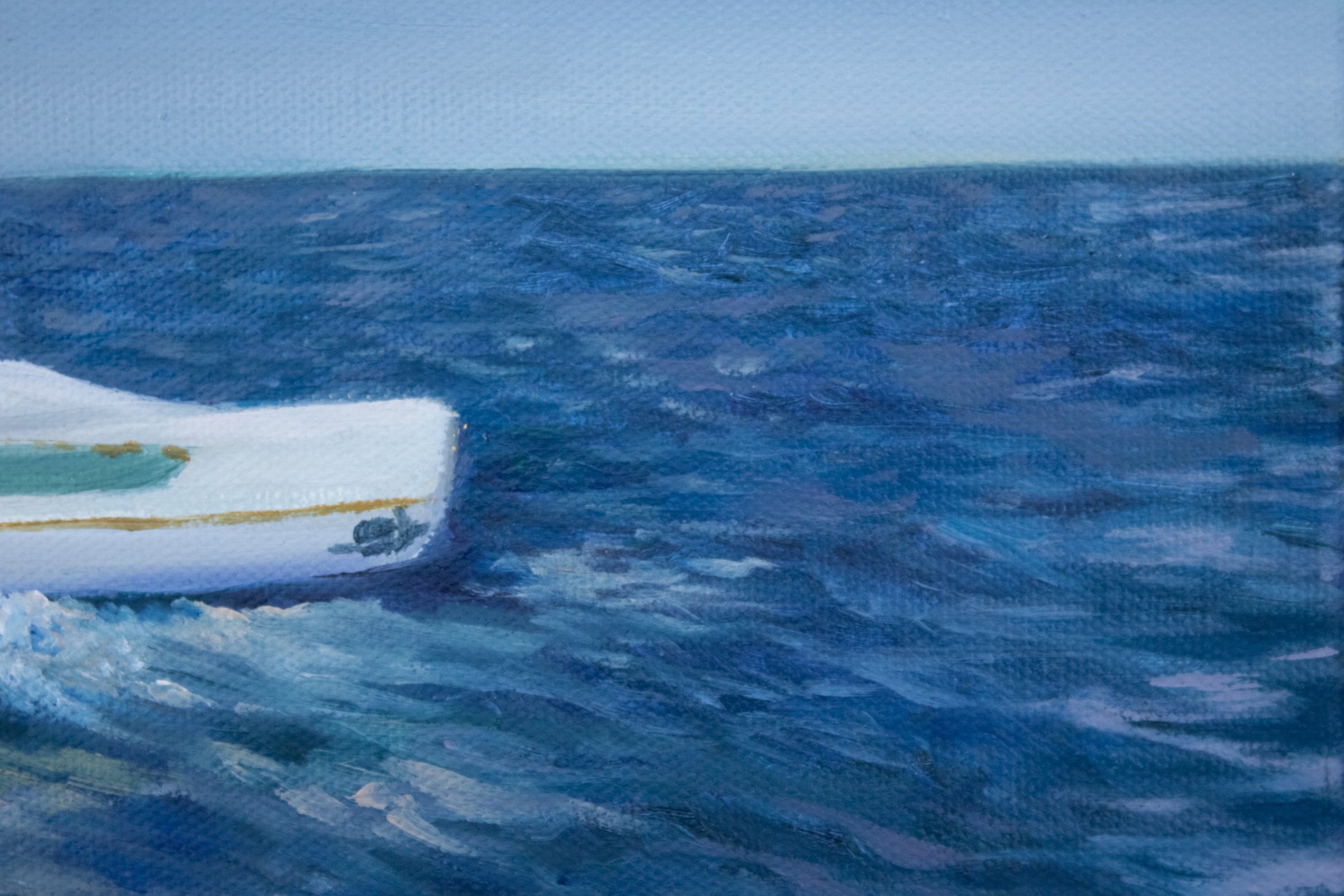 Small boat on a large body of water with a clear sky close up