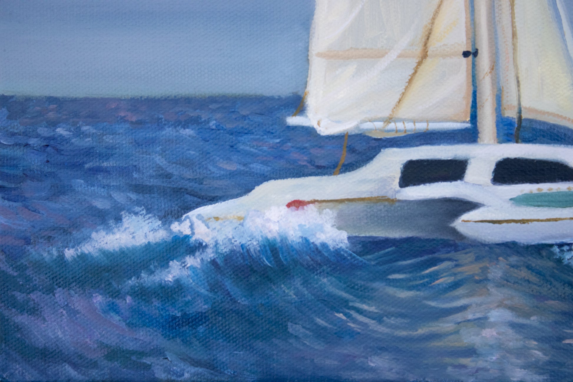 Close up of a sailboat on choppy waters with a clear sky