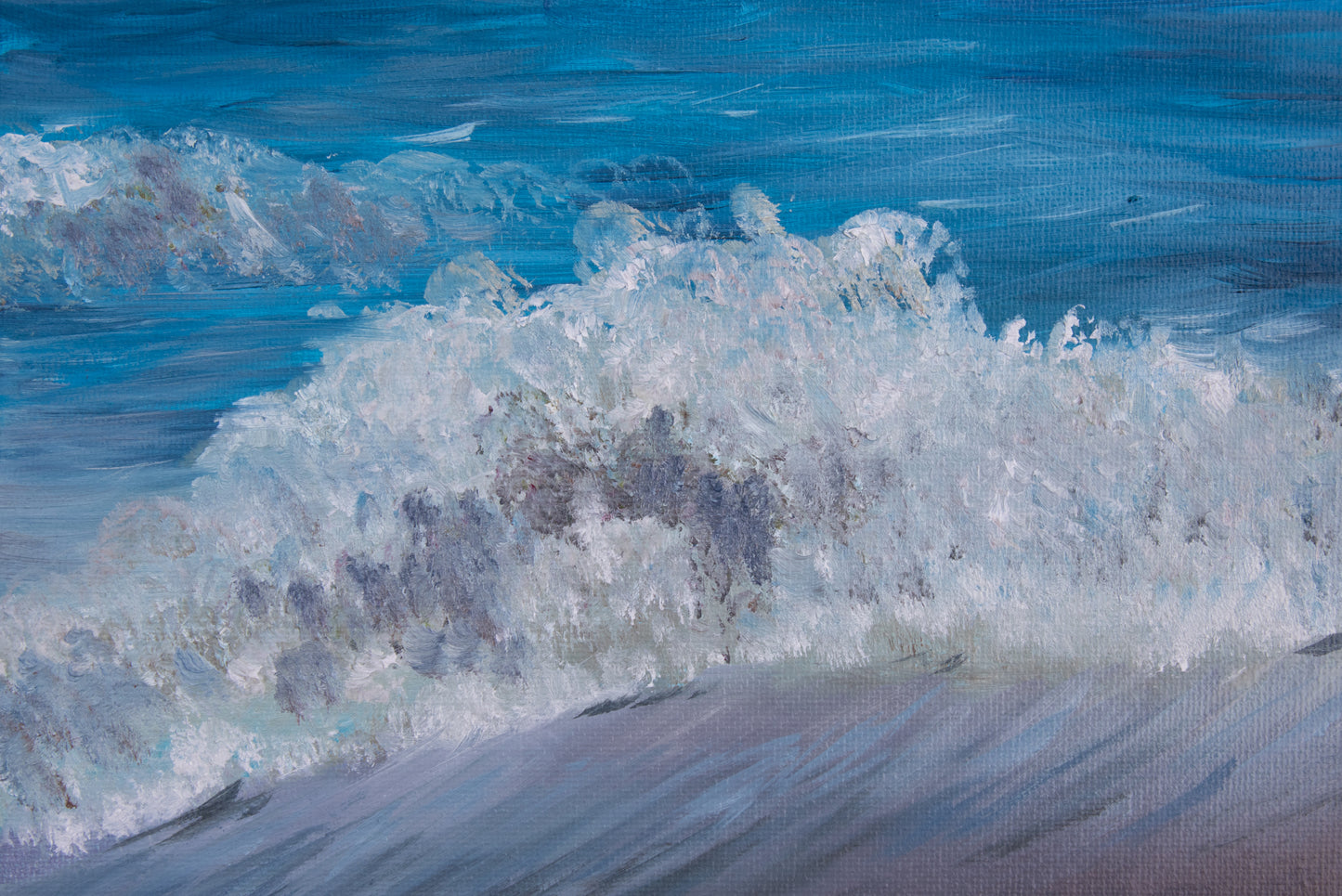 Close-up of a wave crashing on a beach with a textured blue background