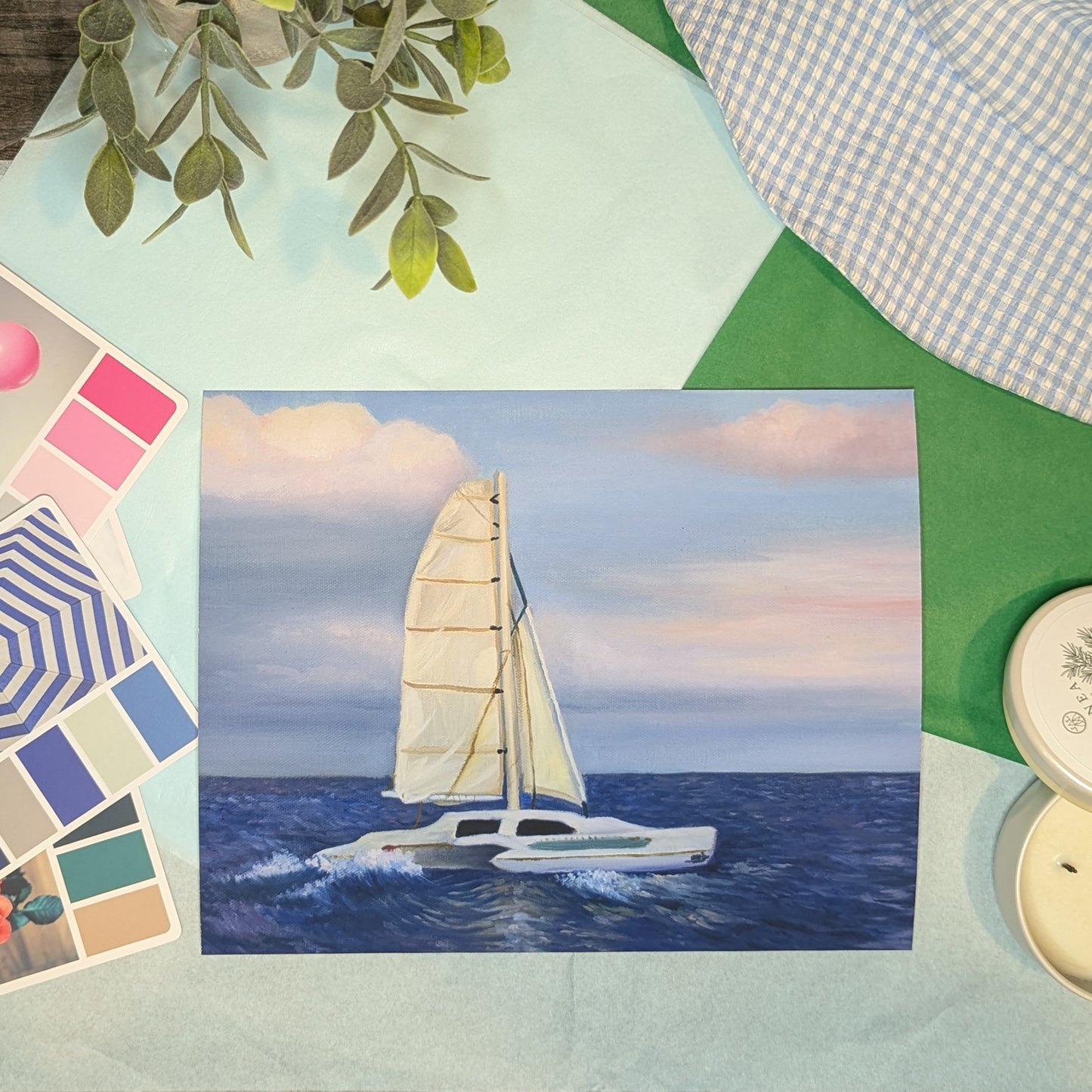 Painting of a sailboat on water with color swatches and buttons in the foreground