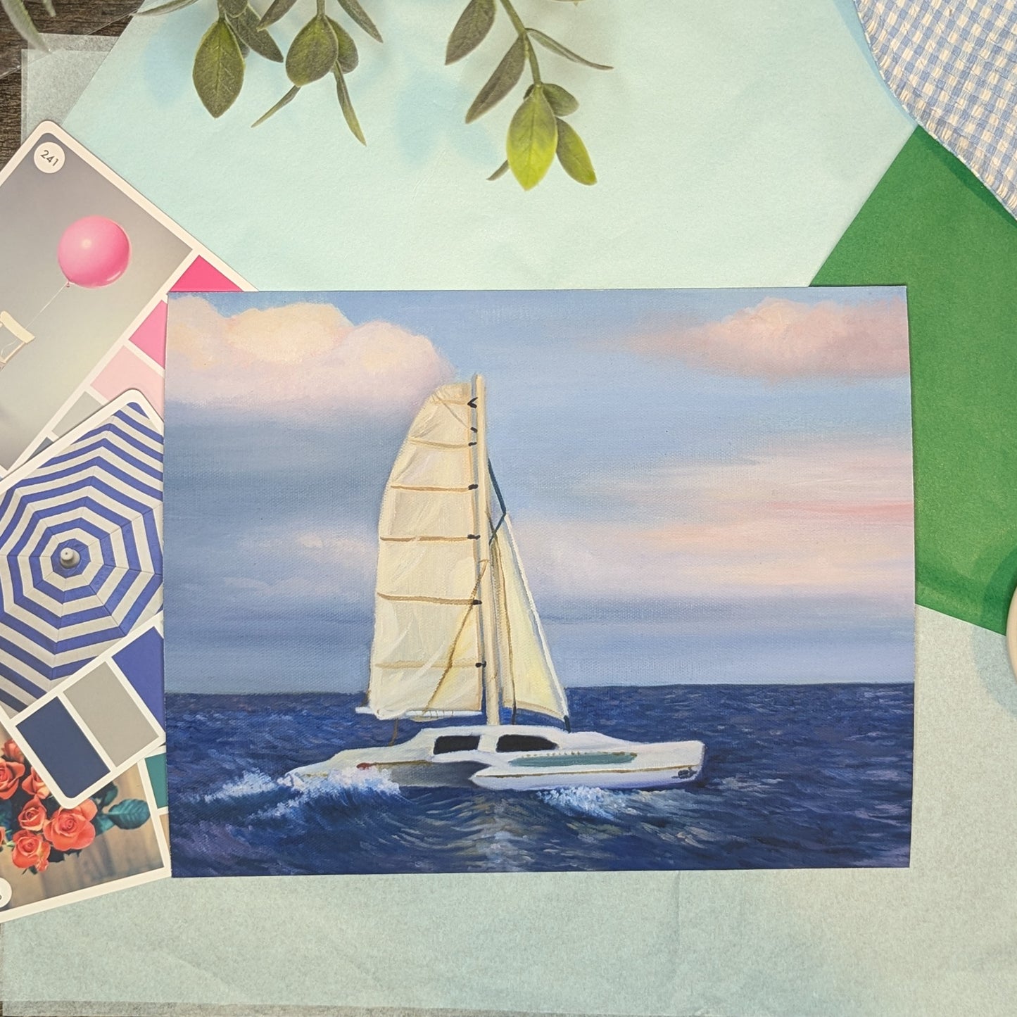 Sailing boat painting on a collage of travel-themed items