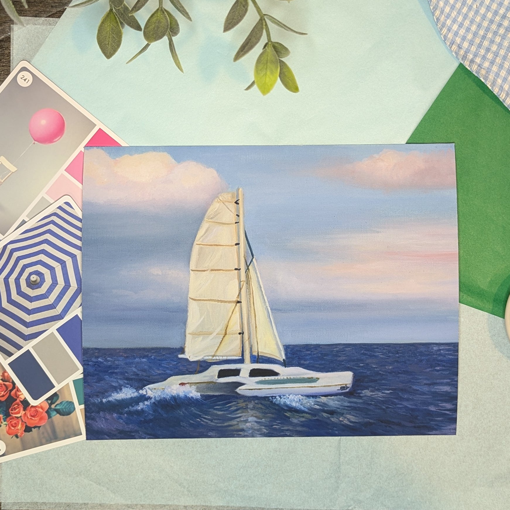 Sailing boat painting on a collage of travel-themed items