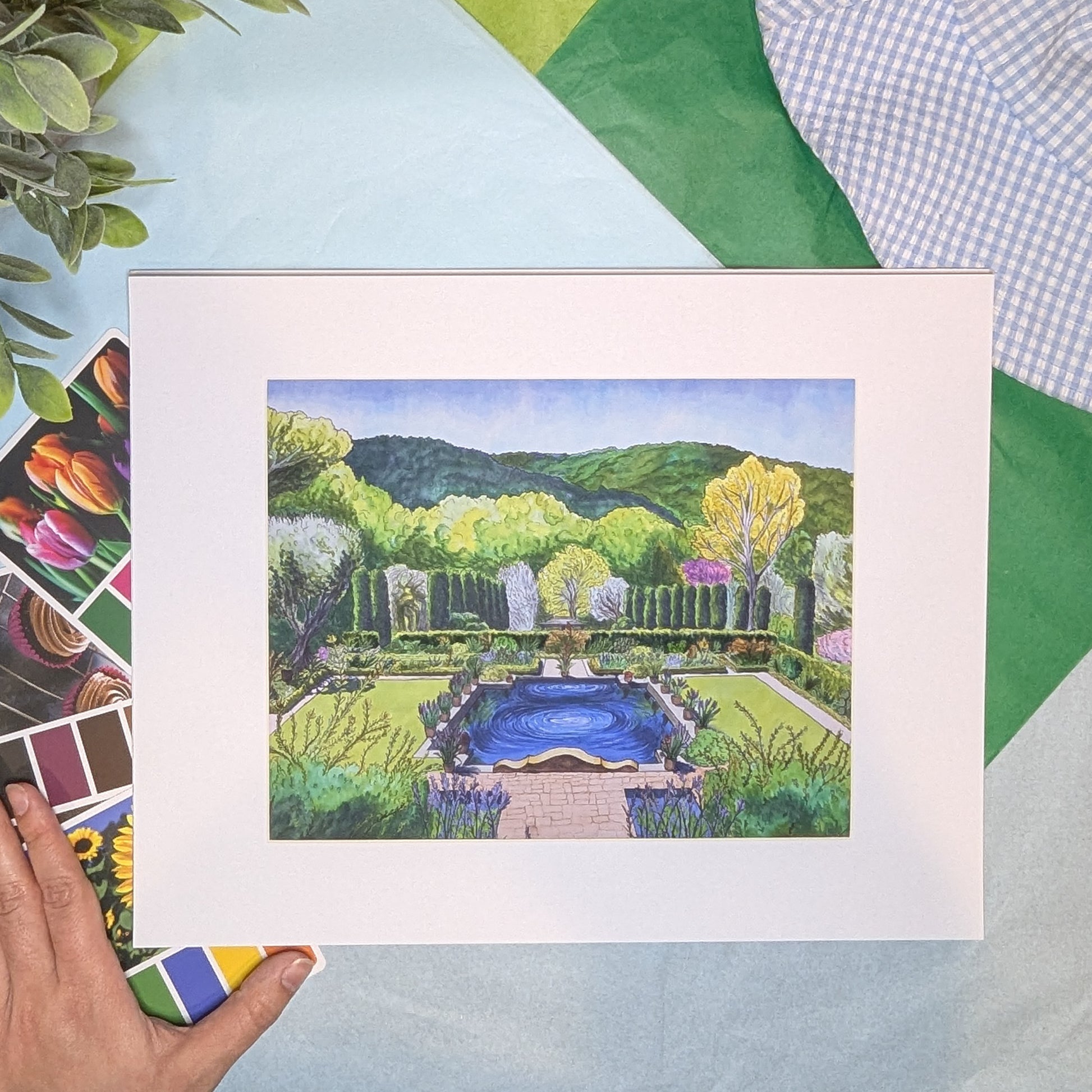 Artistic depiction of a garden scene with a pool, framed on a colorful background.
