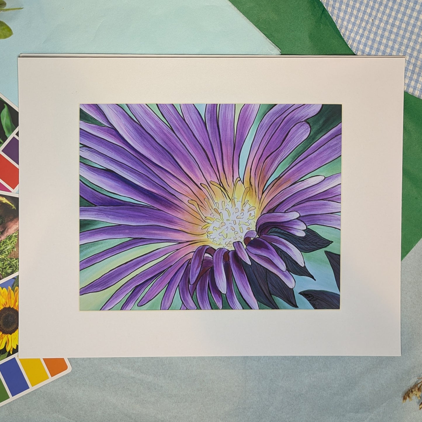 matted artwork of a purple flower with a colorful background