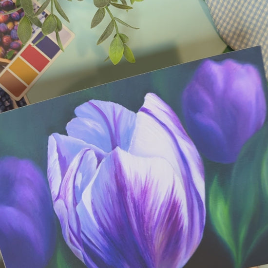 video of the artist holding a print of a painting of purple tulips